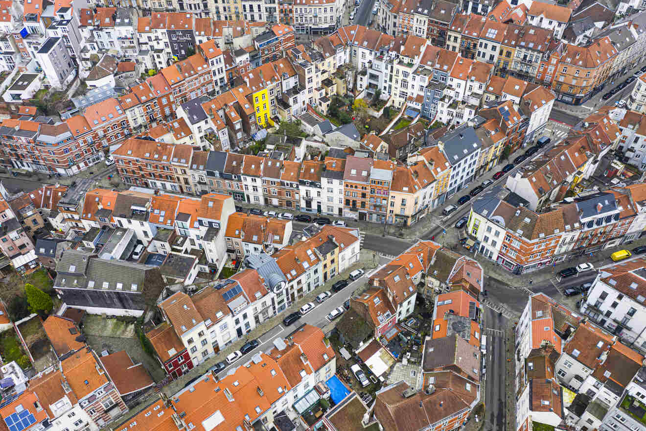 Aerial view of dense urban housing in Brussels, showcasing the patchwork of rooftops and narrow streets